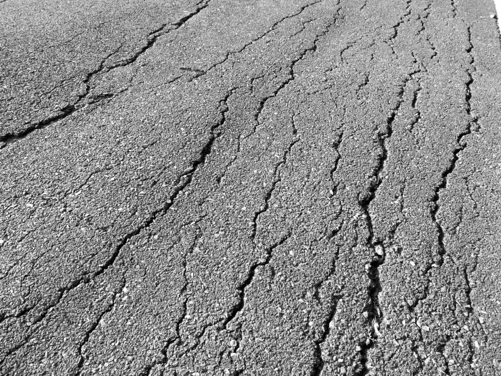 asphalt worn and cracking from frost heaving